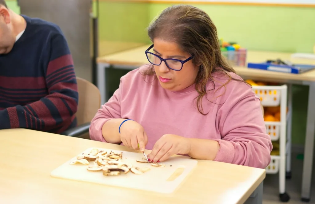 Disabled woman chopping mushrooms